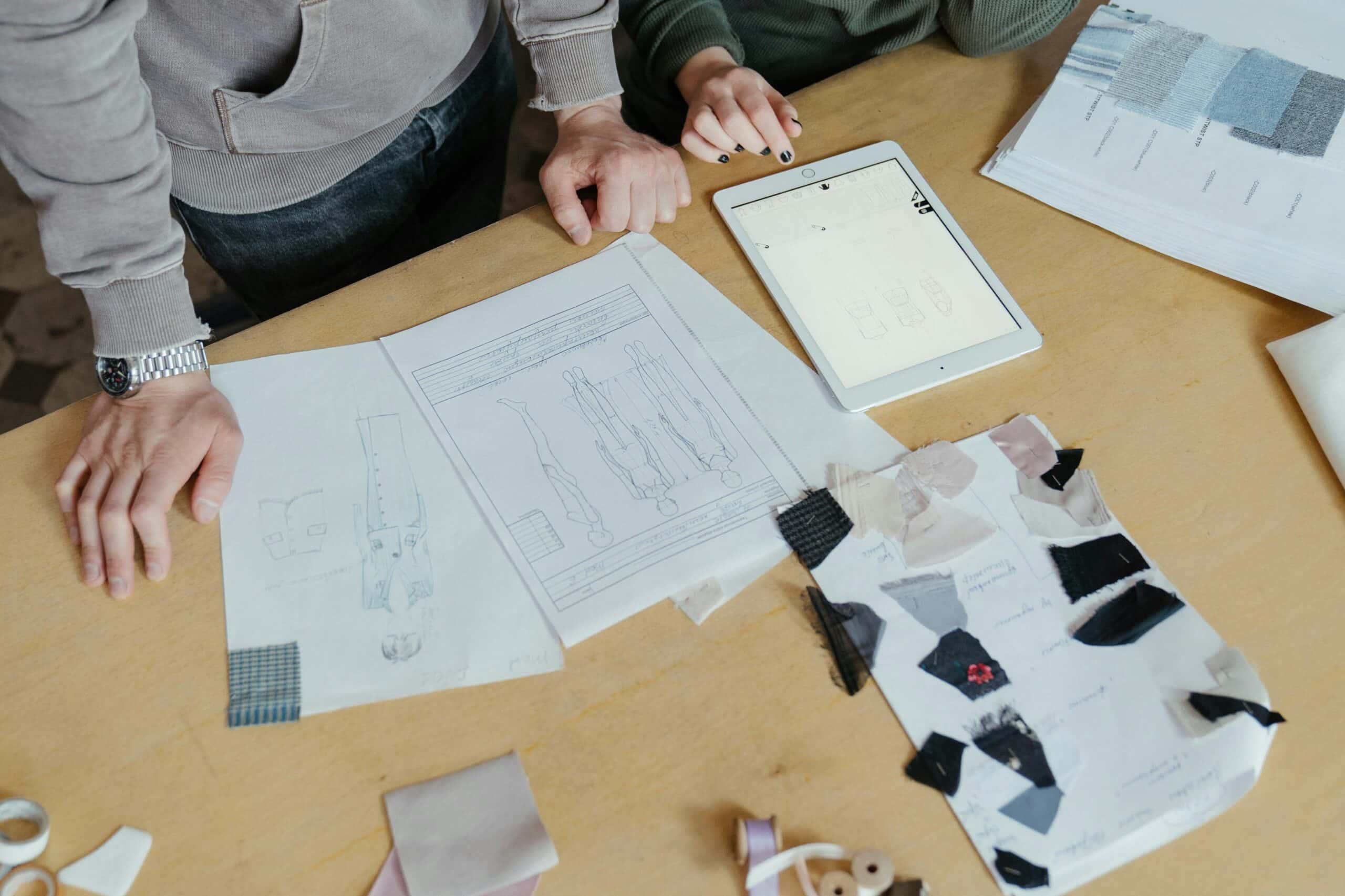 Custom clothing manufacturers reviewing apparel development details