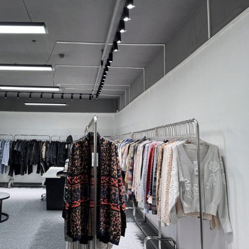 Streetwear manufacturing solutions showroom image with garment racks and sample displays for growing brands